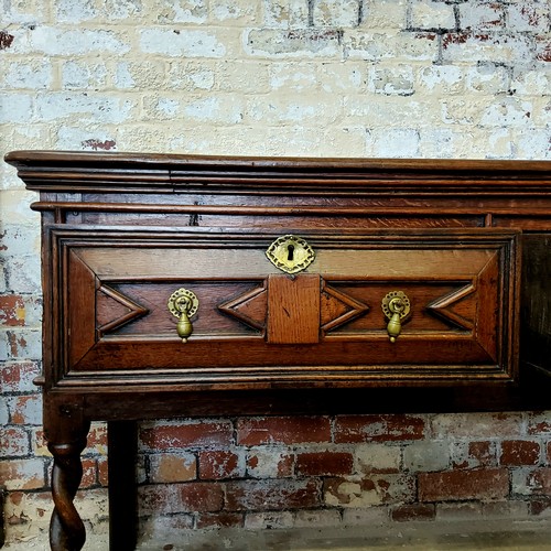 243 - A Charles II oak dresser base, the rectangular two plank top over three geometrically moulded block ... 