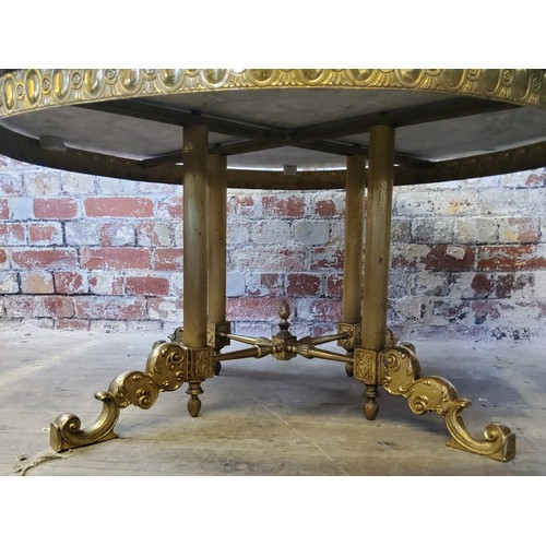 244 - A large Empire taste veined marble topped coffee table, raised on a gilt metal base with four fluted... 