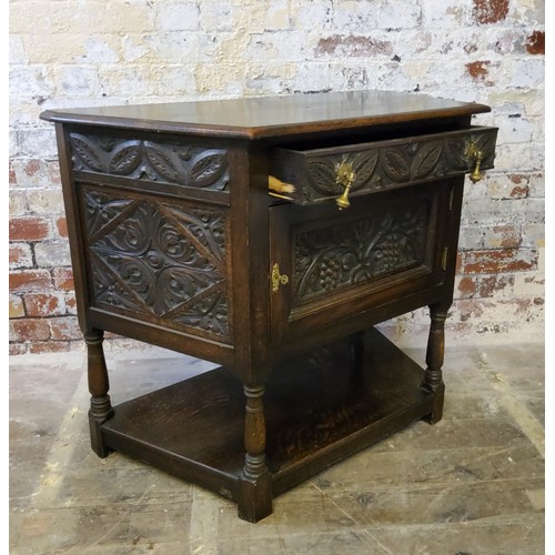 252 - A 19th century Jacobean Revival canted hall cupbboard, heavily carved throughout, single drawer to f... 