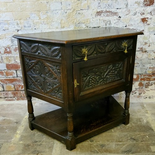 252 - A 19th century Jacobean Revival canted hall cupbboard, heavily carved throughout, single drawer to f... 