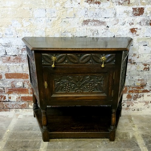 252 - A 19th century Jacobean Revival canted hall cupbboard, heavily carved throughout, single drawer to f... 