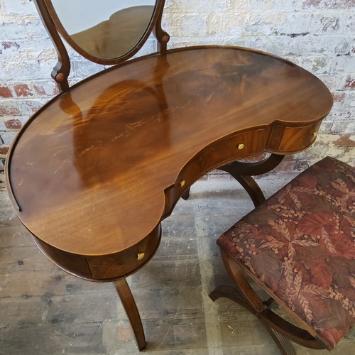 259 - An elegant flamed mahogany and satinwood strung kidney shaped dressing table with shield shaped mirr... 