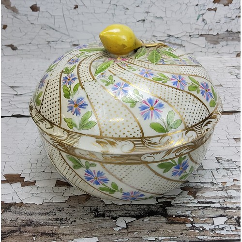 12 - A Meissen bowl and cover, decorated with a gilded swirl design & hand painted with blue flowers,... 