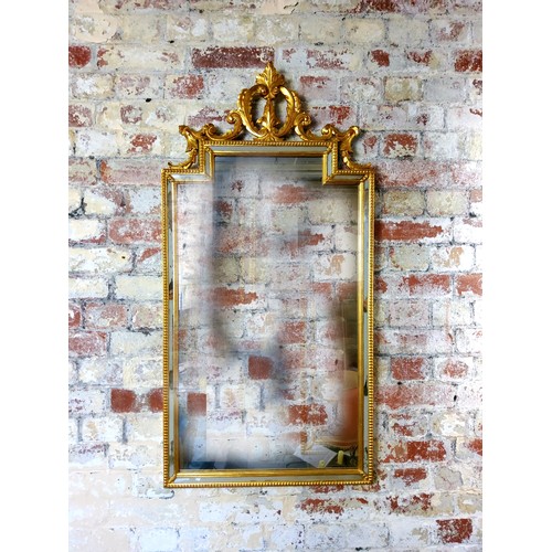 60 - A gilt pier mirror, with stepped top with ornate foliate open scroll pediment, the frame with mirror... 