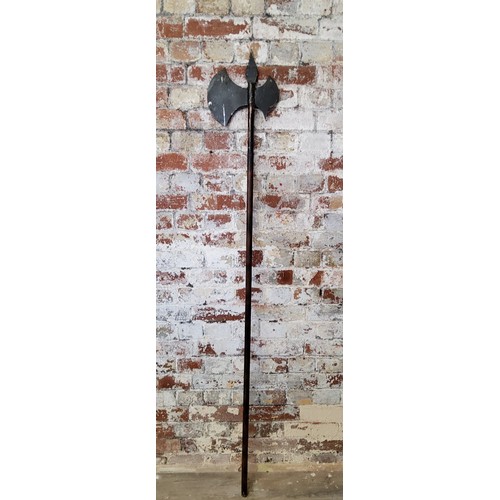 188 - Weapons - a large Medieval battle axe, 174cm high, 20th century