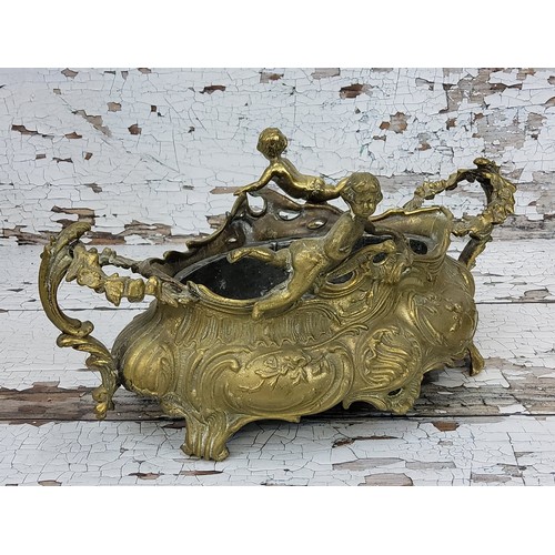 200 - An early 20th century French brass centerpiece, cast in relief with scrolling ecanthus, flora and fa... 