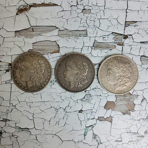 210 - Numismatics- three American Morgan dollars, including an 1882 example, New Orleans mint, VF conditio... 