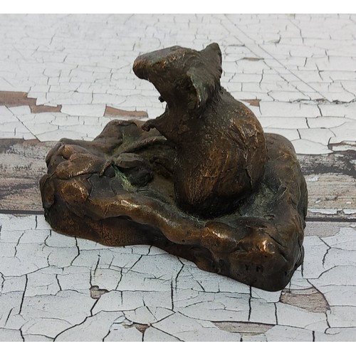 257 - A bronze study of a seated mouse on a naturalistic base, stamped Y M, 5.5cm high