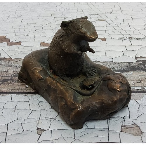 257 - A bronze study of a seated mouse on a naturalistic base, stamped Y M, 5.5cm high