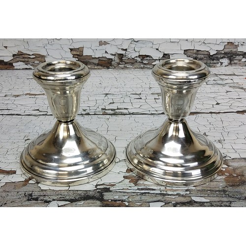 265 - A pair of silver boudoir candlesticks, stamped sterling base (2)