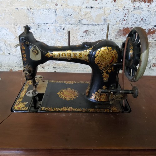 338 - An early 20th century Jones's family C.S. treddle sewing machine, model number 342425, mahogany body... 