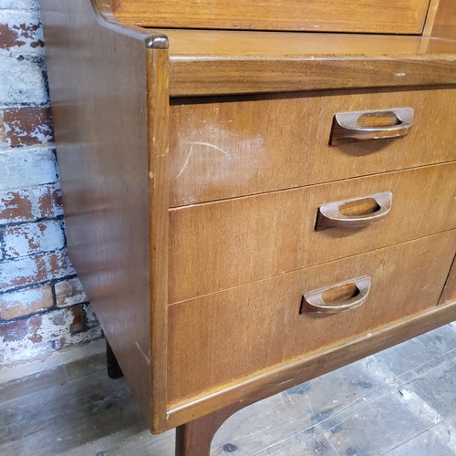 347 - 20th century design - a teak G-Plan Red Label sideboard, three cupboards above niche, step to base e... 