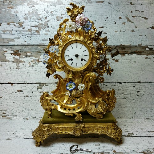 2 - A Napoleon III rocaille gilt metal and porcelain mantel clock, ornate cartouche form applied with en... 