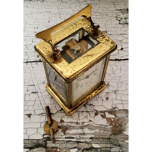 4 - An early 20th century French brass cased carriage clock, the white enamel dial with black Roman nume... 