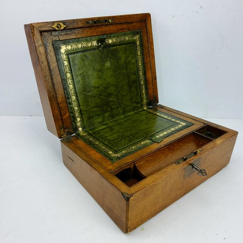 23 - A Victorian golden oak work box, vacant brass cartouche, tooled green leather writing surface c.1860