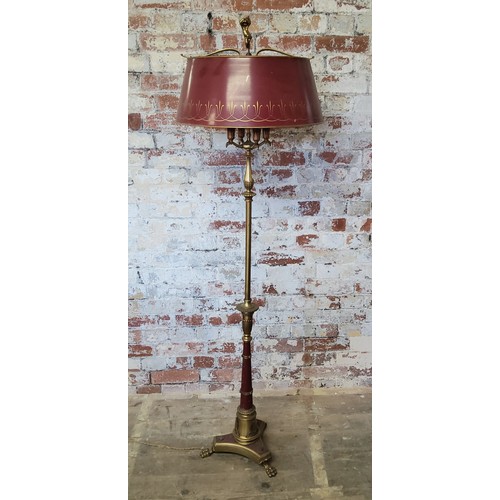 57 - A brass and toleware style four branch standard lamp, cherub finial, burgundy and gold metal shade, ... 