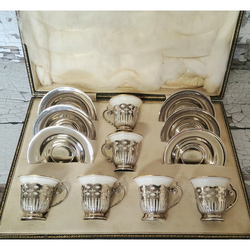 123 - An Art Deco set of six silver coffee cup holders & silver saucers, Lenox ceramic cups, white wit... 