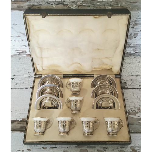 123 - An Art Deco set of six silver coffee cup holders & silver saucers, Lenox ceramic cups, white wit... 