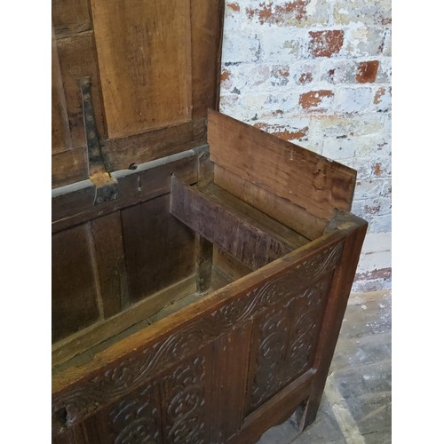 140 - An 18th century English oak coffer,  quite large, the hinged lid with four fluted and cross ban... 