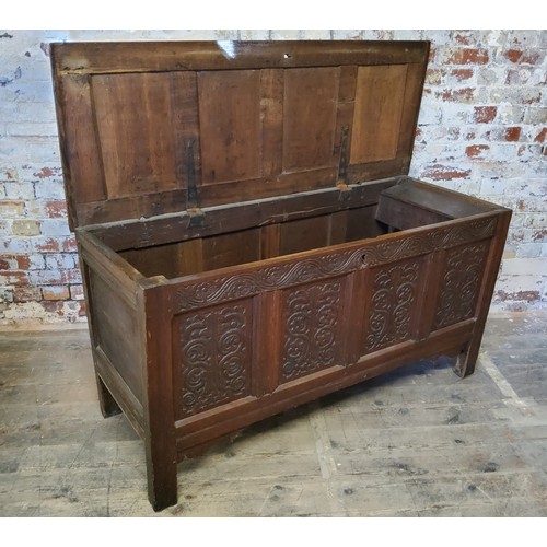 140 - An 18th century English oak coffer,  quite large, the hinged lid with four fluted and cross ban... 