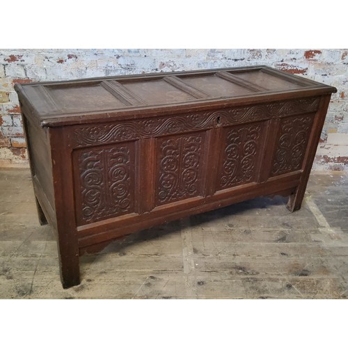 140 - An 18th century English oak coffer,  quite large, the hinged lid with four fluted and cross ban... 