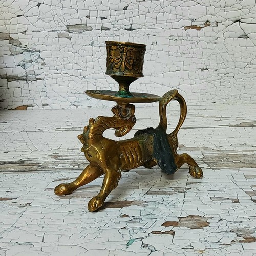 13 - An unusual early 19th century bronze chamberstick, the handle in the form of a mythological beast wi... 