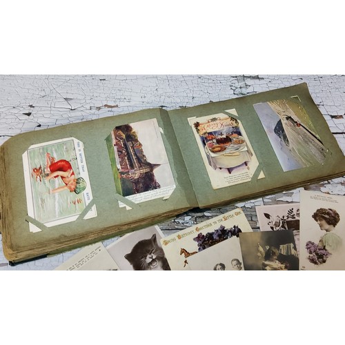 15 - An early 20th century postcard album including embroidered examples