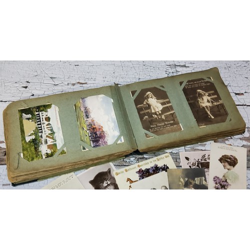 15 - An early 20th century postcard album including embroidered examples