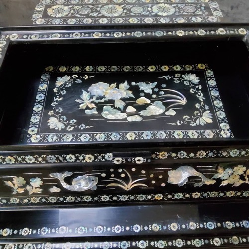 156 - An Asian black lacquered mother of pearl inlaid temple chest of drawers profusely inlaid throughout ... 