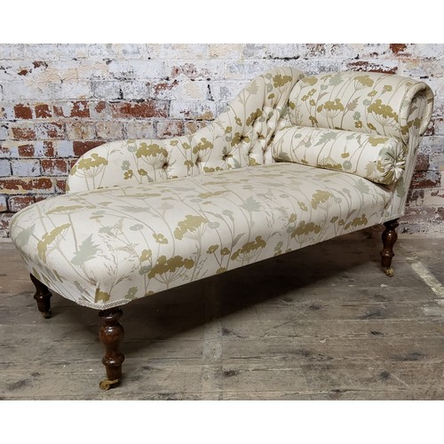 157 - A Victorian type chaise longue, modern upholstery, turned legs terminating in brass castors