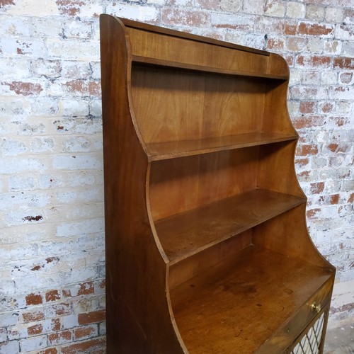 159 - A Regency mahogany freestanding waterfall bookcase, the three ebony strung graduating shelves above ... 