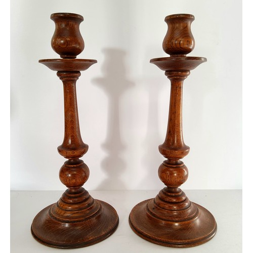 74 - A pair of Arts & Crafts English golden oak turned candlesticks, 33cm high c.1910