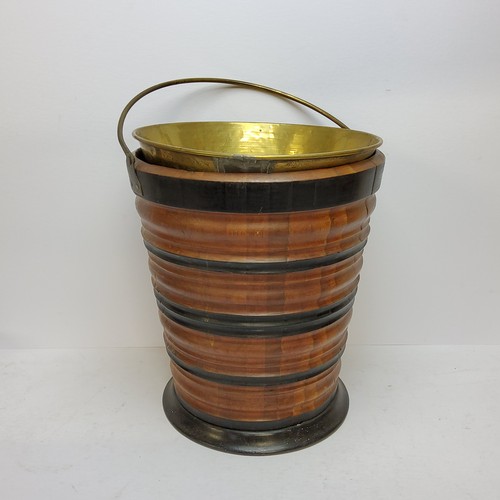 101 - A Dutch walnut and ebonised kettle bucket, decorated with turned banded construction, with a brass l... 