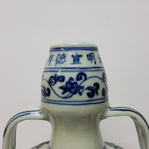 105 - A Chinese Ming style blue and white moon flask, decorated with imperial dragon amongst the clouds, w... 