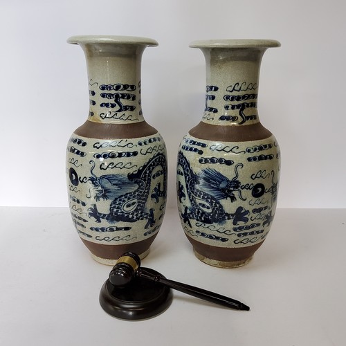 109 - A pair of large Chinese blue and white baluster vases decorated with dragons chasing the flaming pea... 