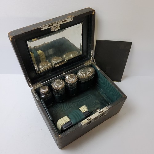 140 - An early 20th century Moroccan leather travelling vanity set, complete with silver plated vanity set... 