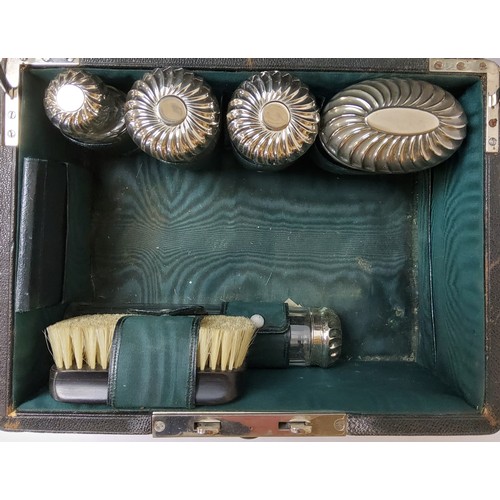 140 - An early 20th century Moroccan leather travelling vanity set, complete with silver plated vanity set... 