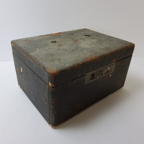 140 - An early 20th century Moroccan leather travelling vanity set, complete with silver plated vanity set... 