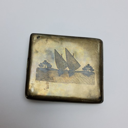 146 - Am Middle Eastern white metal niello cigarette case, obverse depicting village scene and the reverse... 