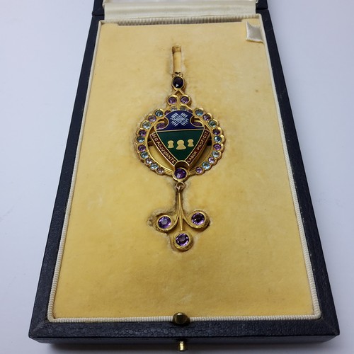 156 - Local interest - a 9ct gold and enamel lady's pendant/brooch, set with light blue and purple stones,... 