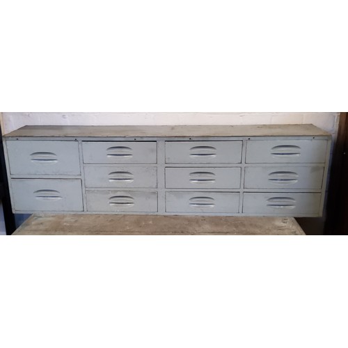 256 - Interior Design - a bank of eleven industrial drawers, 117cm x 31 x 22cm