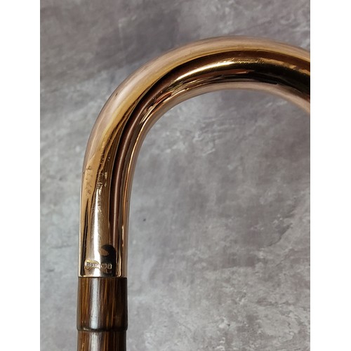 97 - An Edwardian gentleman's tapering bamboo walking cane, the crook handle covered in 9ct rose gold, ha... 