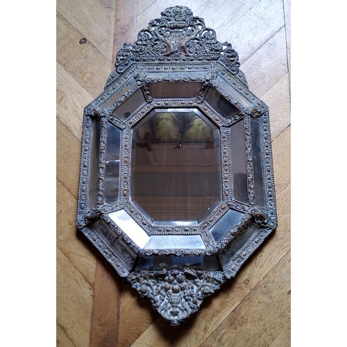 23 - A large 19th century Continental repousse brass cushion frame mirror, planked back93 x 55cm (af)... 