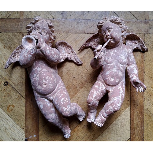 45 - A pair of wall hanging plaster putti playing trumpets, terracotta effect (one missing trumpet) appro... 