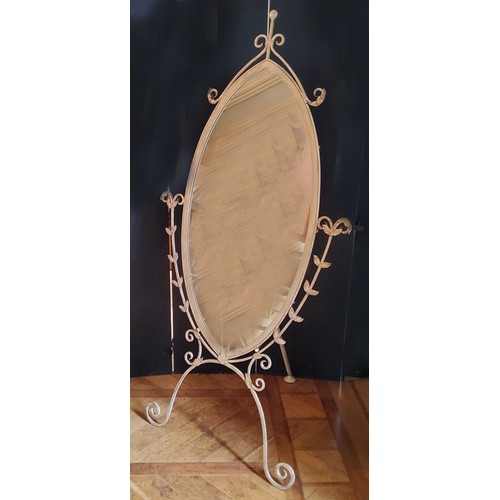 47 - A large oval shaped wrought iron cheval mirror, distressed cream finish 185cms high