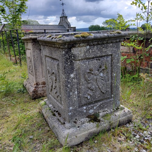 54 - A pair of reconstituted gritstone garden plinths, Neo Classical ribbon tied bow decoration to each s... 