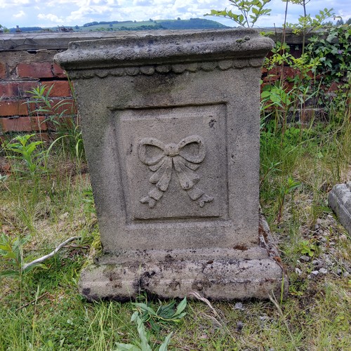 54 - A pair of reconstituted gritstone garden plinths, Neo Classical ribbon tied bow decoration to each s... 