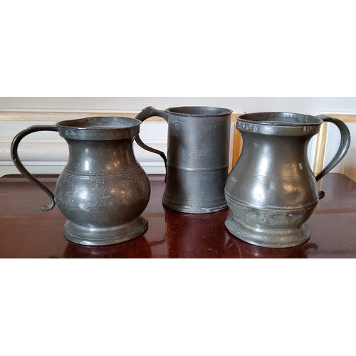 72 - A George IV pewter quart tankard, stamped with GR to ER stamps; another stamped MW & Imperial et... 