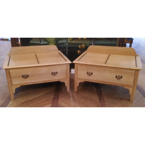 90 - A pair of 20th century limed oak luggage stands with fixed guilt metal protective runners, one long ... 