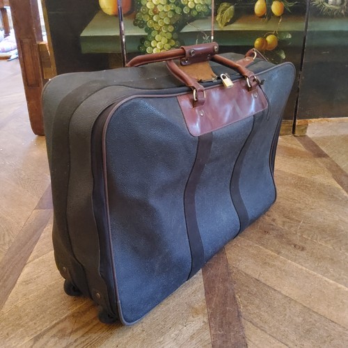 93 - A genuine Mulberry suitcase, large size, in original protective cover, 68w x 50h on casters